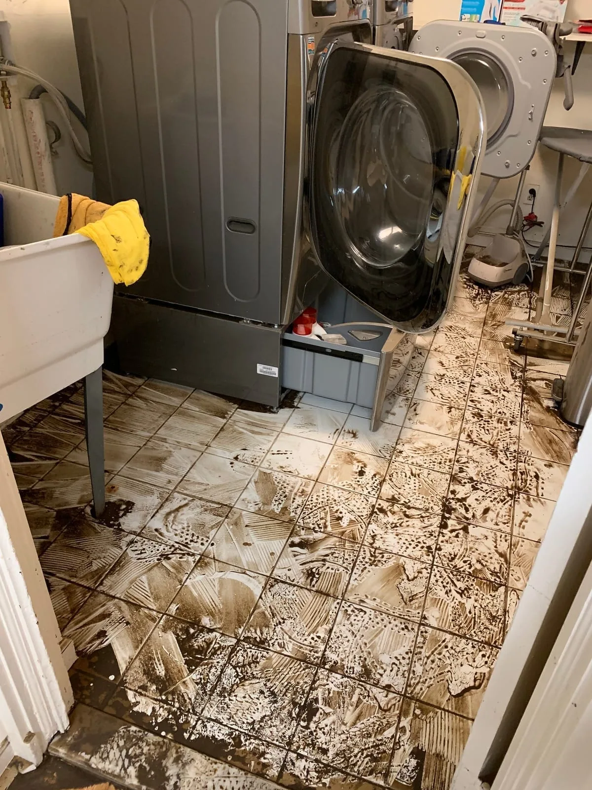 Floodwater spreading across a residential interior after severe coastal storm damage