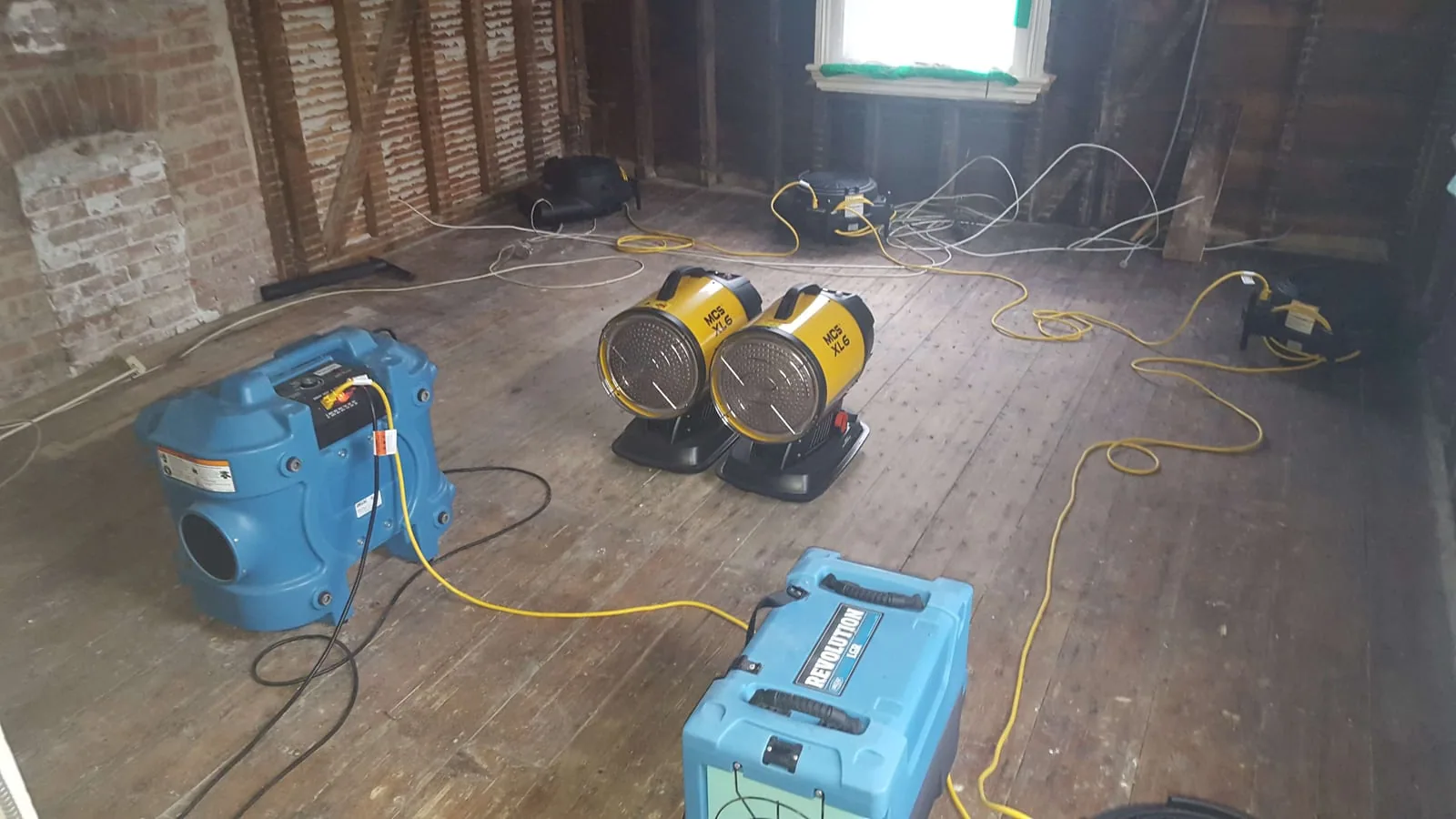 Mold mitigation and structural drying in progress with HEPA scrubber and air movers