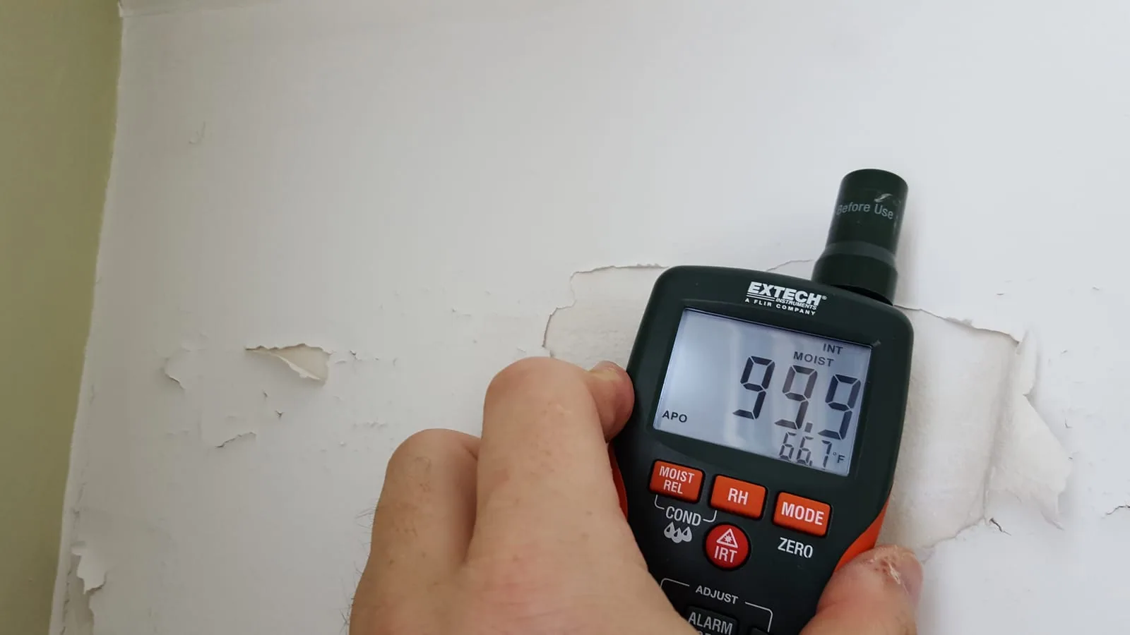Peeling and bubbling paint on wall caused by hidden water damage