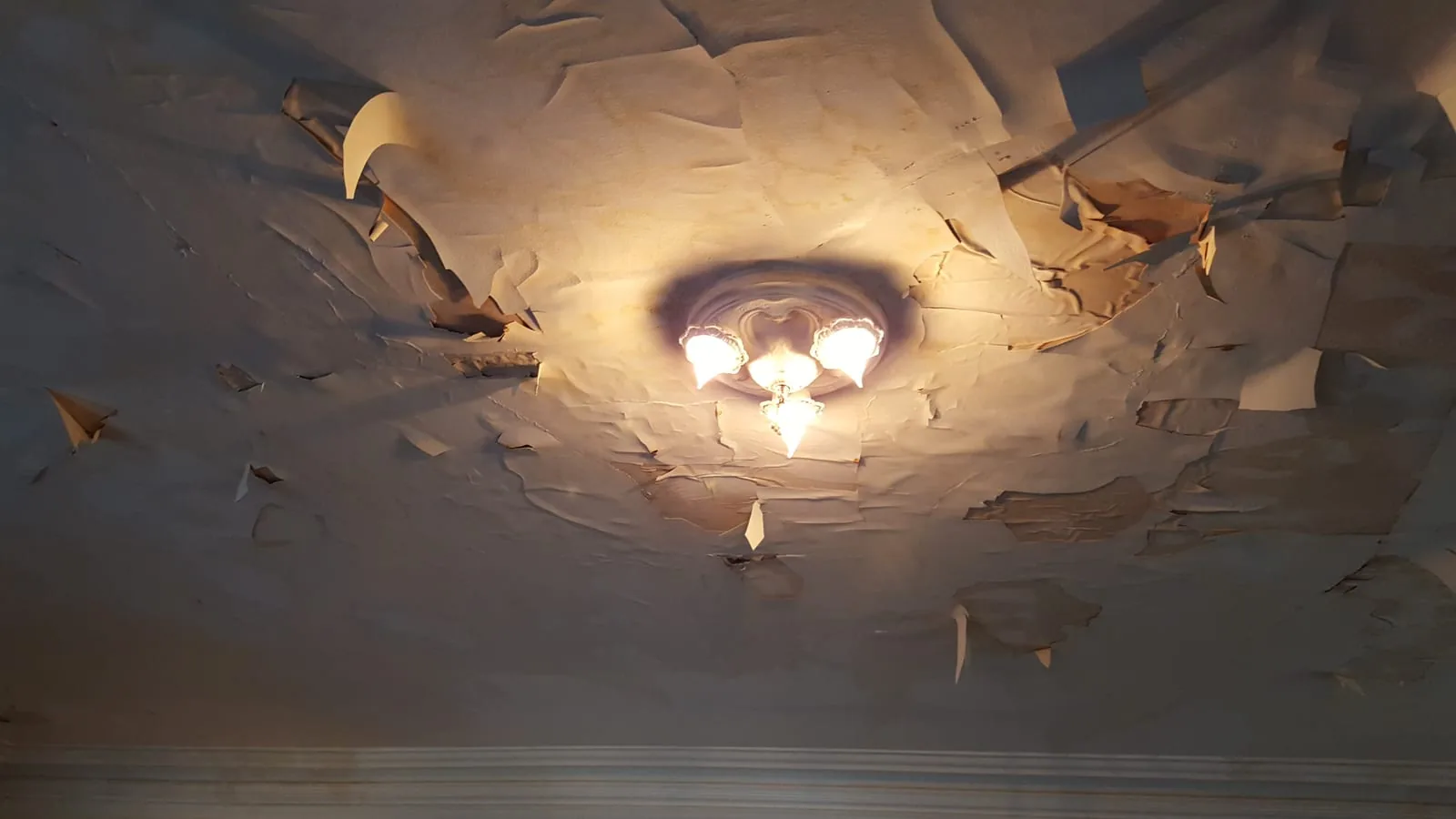Severe water damage causing plaster ceiling failure around chandelier — IICRC S500 water damage restoration in a Fairfield County CT home